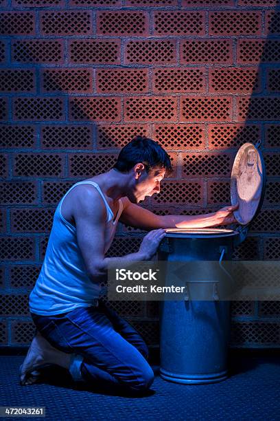 Surprised Man Looking Into Glowing Garbage Can Stock Photo - Download Image Now - 30-39 Years, Adult, Adults Only