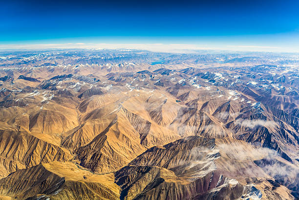 aerial view of mountains and clouds on top