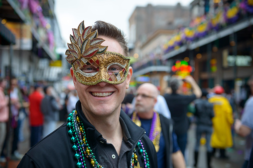 New Orleans, USA - February 10, 2013: A smiling face in the crowd of Mardi Gras revelers on Bourbon Street.