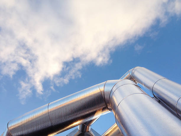 istock Steel pipes with cloudy sky background 472044061