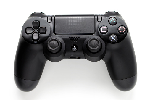 Milan, Italy - November 29, 2013: close-up of a joypad for Play station 4 on white background. The PlayStation 4 is a video game console produced by Sony Computer Entertainment.