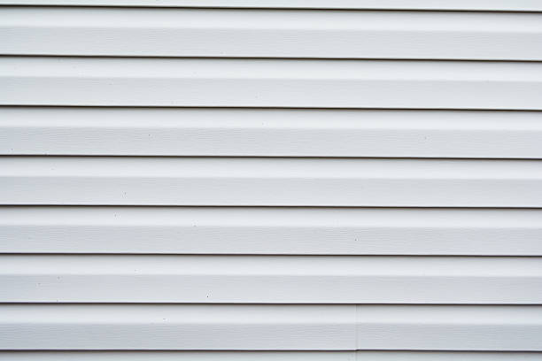 istock Vinyl siding in a pale gray color background 472045420