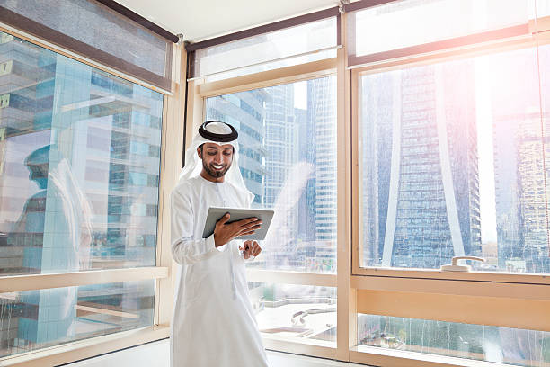 istock Arab businessman using digital tablet in Dubai office 472045874
