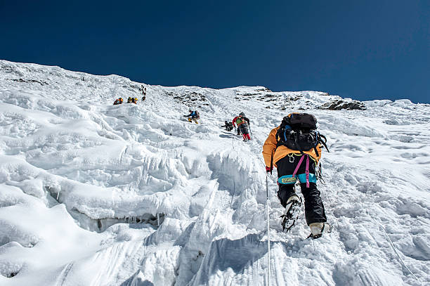 Ice climbing Island Peak,Nepal-April 07,2012:The Climbers climbing the ice wall to the top of Island Peak (Imja Tse) summit(6189m) in the Himayalas Everest region,Nepal. solu khumbu stock pictures, royalty-free photos & images