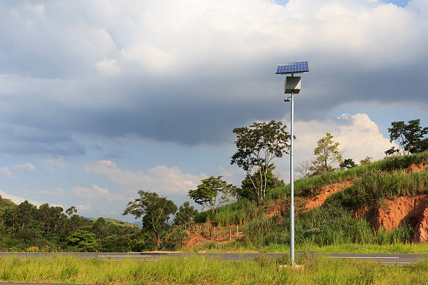 Electric pole with solar panel on road in countryside Electric pole with solar panel on road in countryside, use of Solar energy for lightning of highway, Rio de Janeiro, Brazil concentrated solar power photos stock pictures, royalty-free photos & images