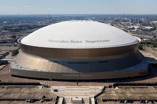 New Orleans,  Louisiana, USA - October 9, 2013: The Mercedes-Benz Superdome  in New Orleans, Louisiana is home to the NFL's  New Orleans Saints American football and NCAA's Tulane University . The Stadium also host  Sugar Bowl , New Orleans Bowl, Bayou Classic college football games. 10 Super Bowls have been played in the statium. The stadium host many other sporting events including baseball, basketbal, boxing, soccer, gymnastics and motorcross. 