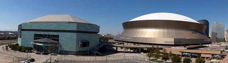 New Orleans,  Louisiana, USA - October 9, 2013:New Orleans Sports and Entertainment Complex (panoramic)  with the New Orleans Arena (left) and the Mercedes-Benz Superdome (right)