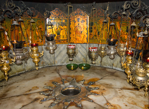 Bethlehem, Israel - July 19, 2008: Fourteen-point silver star, beneath altar in the Nativity Grotto, marks spot of the birthplace of Jesus Christ by the Blessed Virgin Mary.