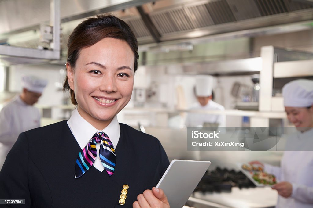 Restaurant Hostess in an Industrial Kitchen 25-29 Years Stock Photo