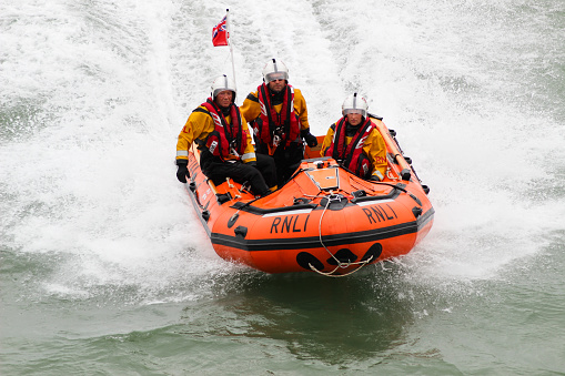 Eastbourne, UK - 17 August, 2013: Royal National Lifeboat Institution (RNLI) in-shore crew on duty at the Eastbourne Air Show on the English Channel, UK on 17 August, 2013.