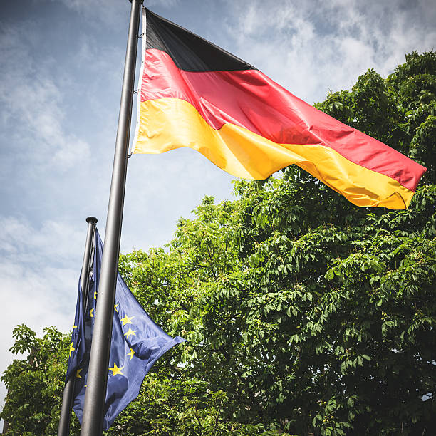 istock German flag waving on the sky 472049097