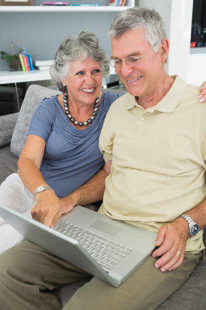 istock Mature couple watching something on laptop 472049325