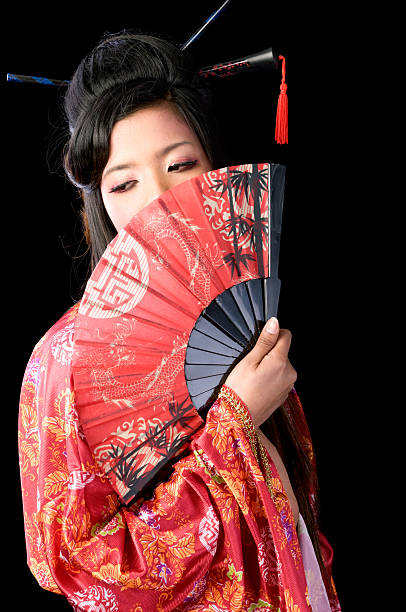 istock Modern geisha with fan over mouth, looking away. 472049369
