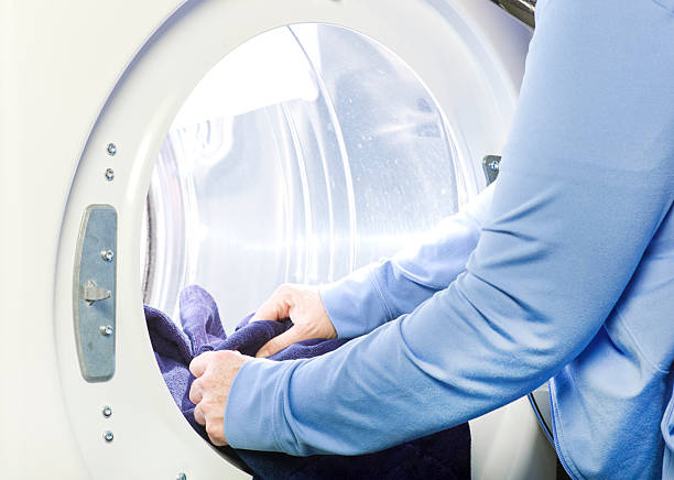 istock Mature or Senior Woman Doing Laundry. 472049631