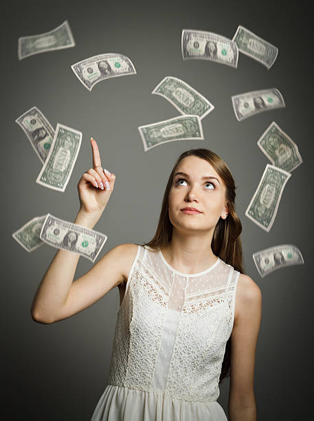 istock Young girl in white and dollars. 472050016