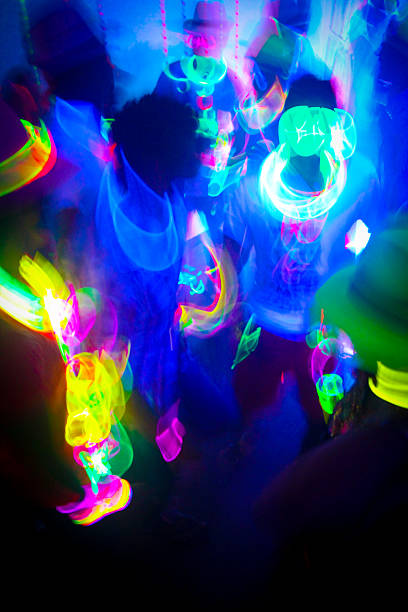 Neon Glow Party Crowd Neon Glow Party Crowd glow stick stock pictures, royalty-free photos & images