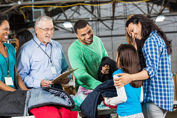 istock Diverse volunteers accepting coat donations at clothing drive 472051497