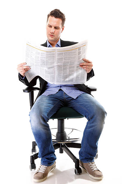 istock Businessman reading a newspaper isolated 472051969
