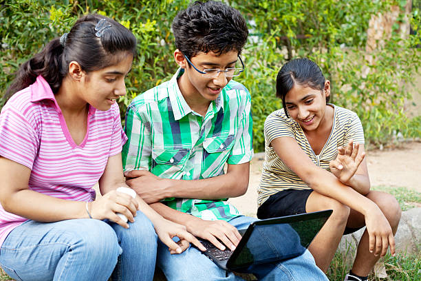 istock Cheerful group of Indian Teenagers using laptop 472052907