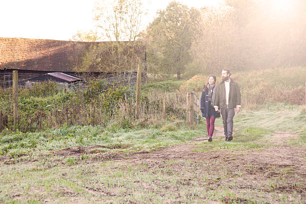 istock Young couple on a country walk 472053057
