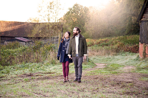 istock Young couple on a country walk 472053139