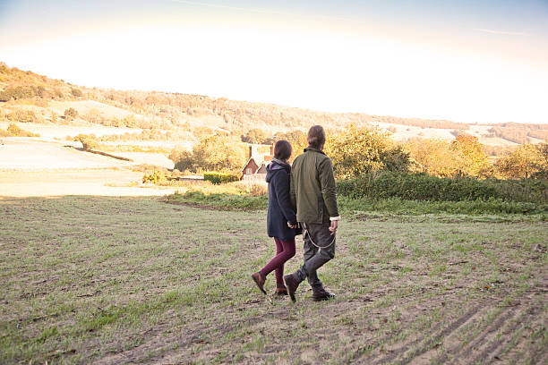 istock Young couple on a country walk 472053211