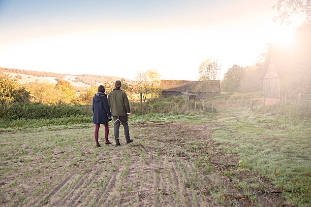 istock Young couple on a country walk 472053239