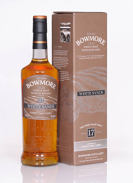 Bowmore white sands Bayreuth, Germany – April 26, 2015: bottle and presentation box of a 17 years old Scottish single malt whisky from the distillery Bowmore, situated on the isle Islay.  bowmore whisky stock pictures, royalty-free photos & images