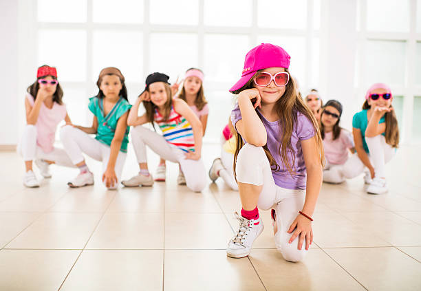 Little hip hop dancers. Large group of little hip hop dancers in a dance studio looking at the camera. Focus is on foreground.   dance troupe stock pictures, royalty-free photos & images