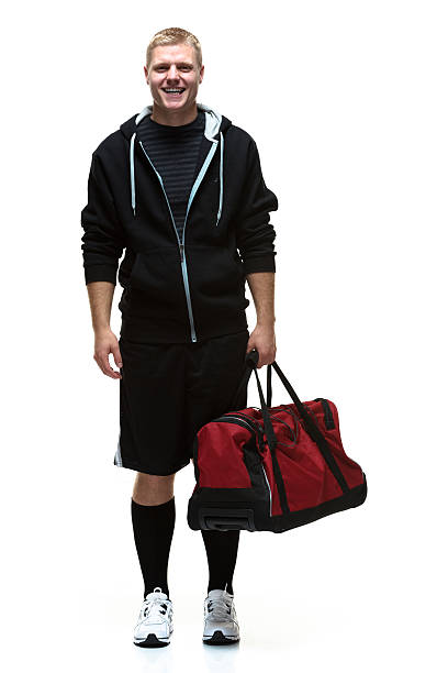 istock Happy college student holding travel bag 472054345