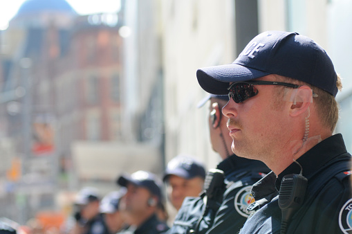 Toronto, Canada - October 2, 2009: Toronto police cops keeping an eye on the mob while standing on the sidewalk during the G20 Protest.