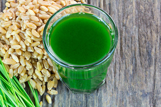 istock Wheat grass juice on wood background 472055563