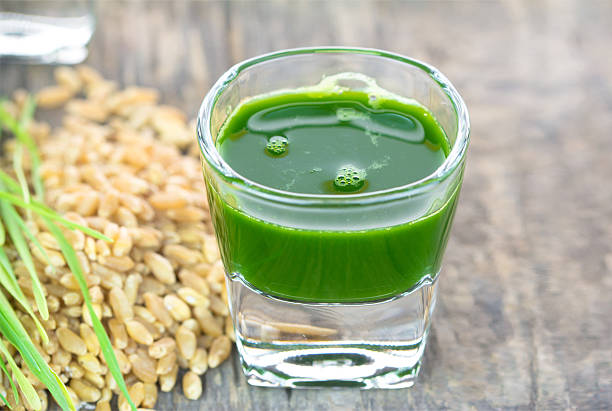 istock Wheat grass juice on wood background 472055777