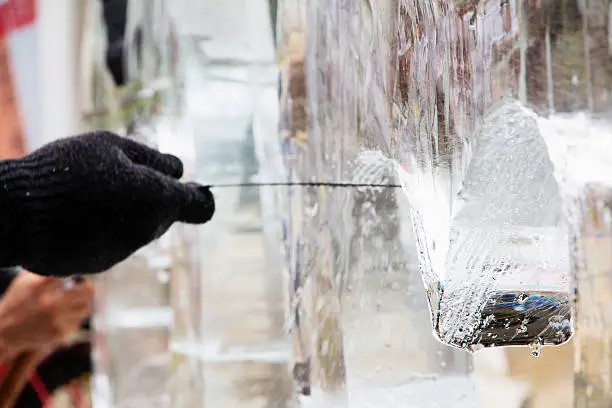 Ice Carver Using Chisel to Carve 