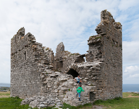 Inisheer, Ireland - August 19, 2013: Children playing on the castle ruins on the top of the island Inisheer, one of the aran islands in Galway bay