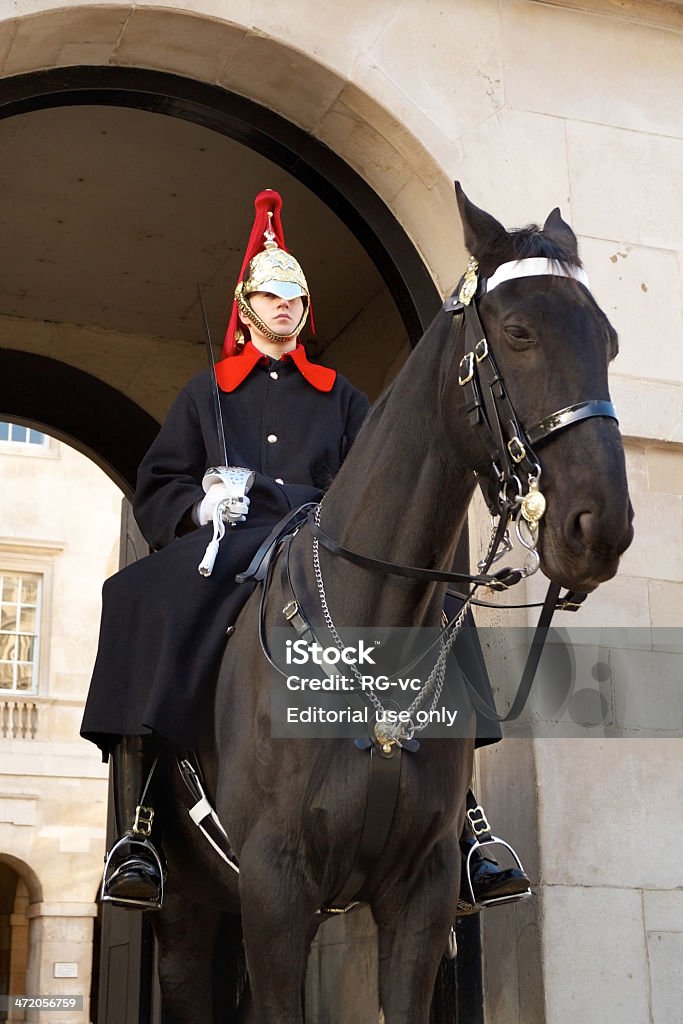 Mounted Household Cavalry guard London, England - November 15, 2013: Member of the Royal Horse Guards stands outside the entrance to the listed Horse Guards in Whitehall. Designed by William Kent, the building was completed in 1755 Horse Stock Photo