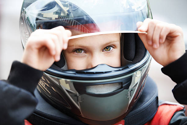 Portrait of a young racer in helmet Portrait of a young racer in helmet closeup kids Motorbike Helmets stock pictures, royalty-free photos & images