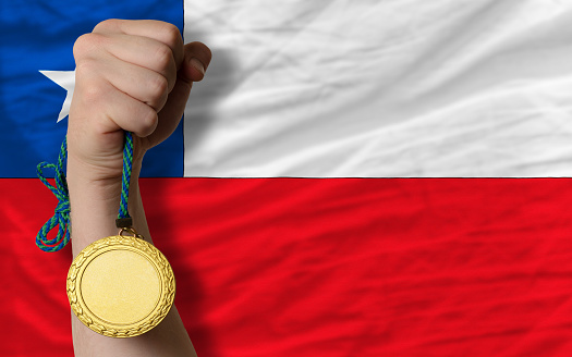 Winner holding gold medal for sport and national flag of canada