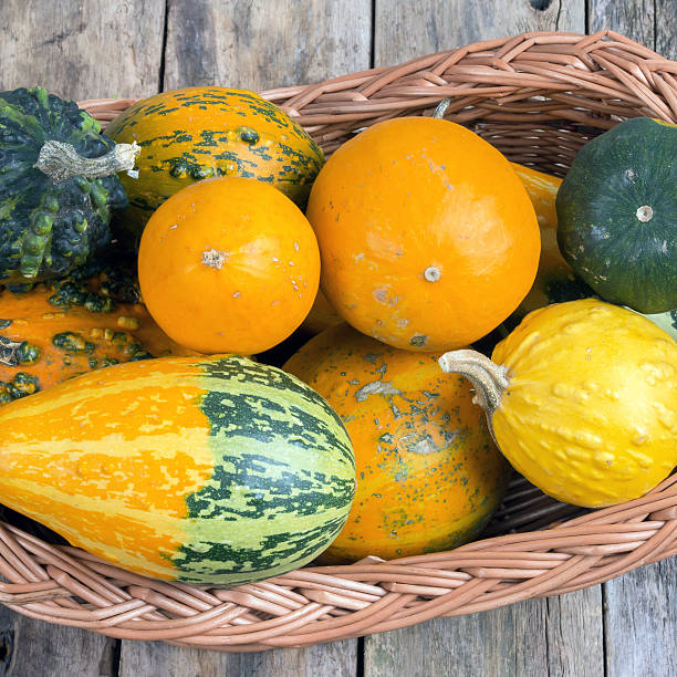 istock Pumpkins on a wooden table and basket 472058583