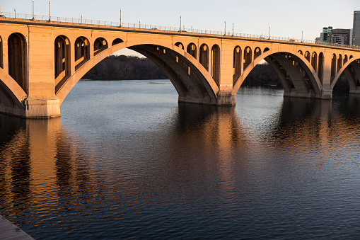 Key Bridge in Georgetown Washington DC at sunset showing reflections on the Potomac River