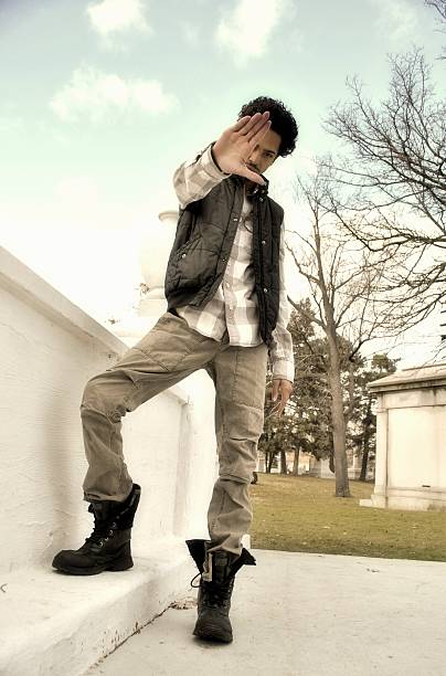 istock young black man holding his hand to one side 472059339