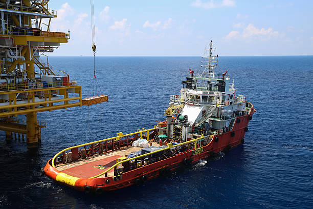 A barge docking on to an offshore construction platform stock photo