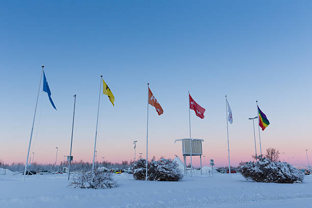 Kiruna, Sweden - January 21, 2015: A winter view of the outside of the domestic airport terminal in the city of Kiruna in the North of Sweden. Shows entrance doorway with parked cars and control tower.