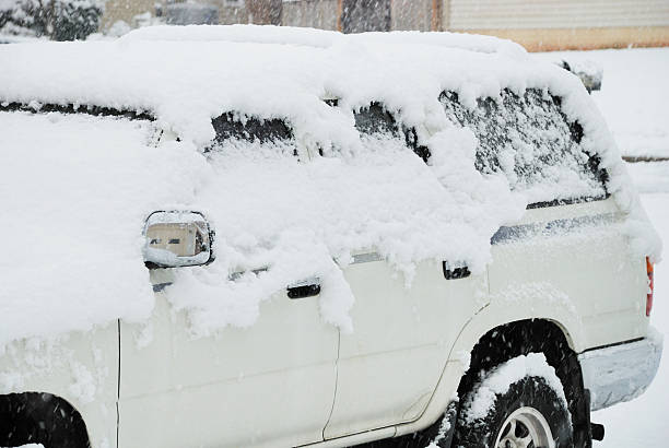 istock Snowstorm covers car with snow 472061675