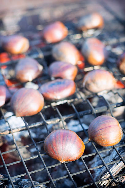 istock Chestnuts roasting on outdoor grill over charcoal fire in winter 472064029