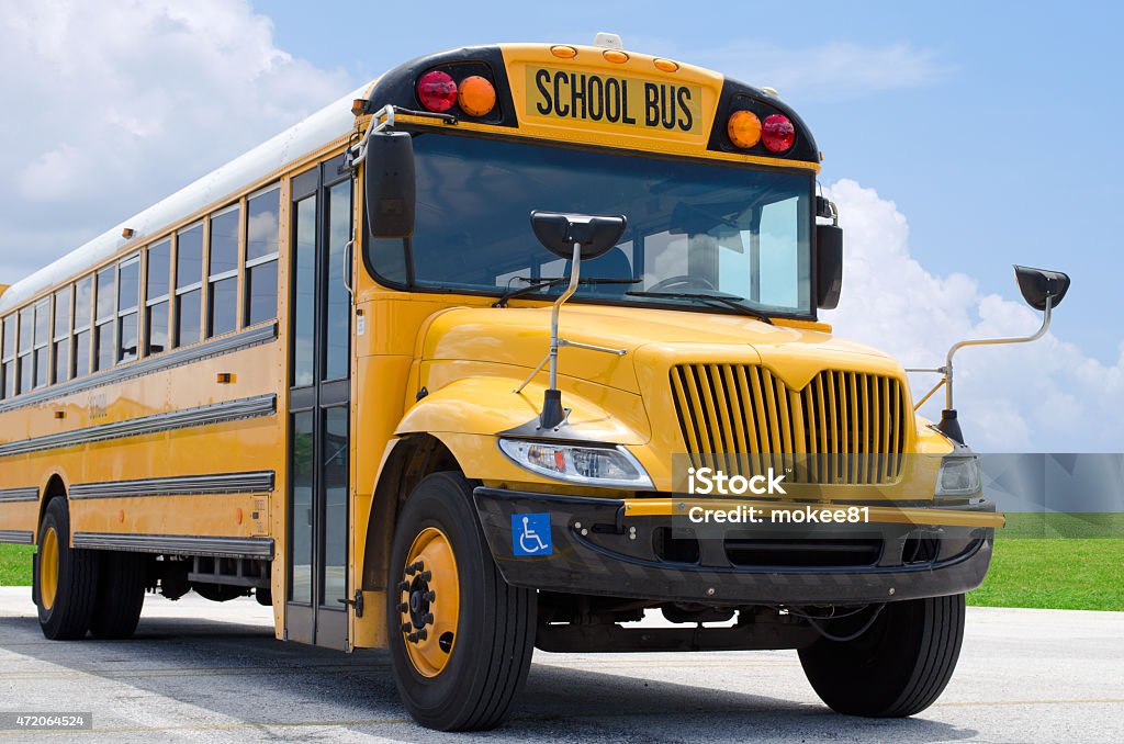 School bus on blacktop with clean sunny background Yellow school bus on the blacktop on a beautiful sunny day.  School Bus Stock Photo