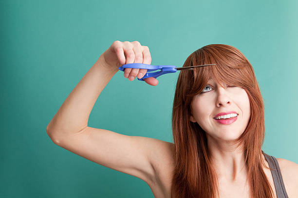 istock Woman Cutting Her Own Hair 472065557