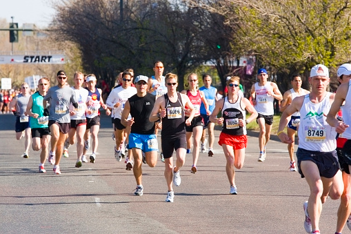 Denver, Colorado, USA  - April 27, 2008: Runners at the starting banner in the Cherry Creek Sneak on Steele Street near Cherry Creek Drive North in Denver Colorado