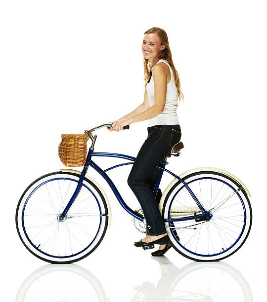 istock Pretty young woman riding a bicycle 472066061