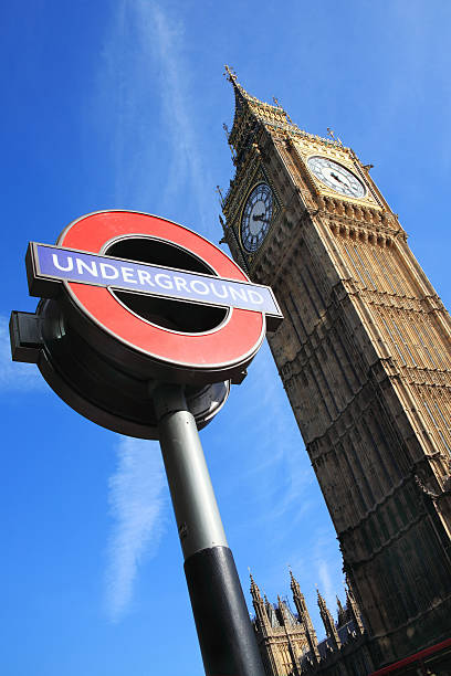 London Underground Sign And Big Ben London, UK - Apr 9, 2011: London Underground sign at Westminster tube station with Big Ben in the background  big ben stock pictures, royalty-free photos & images